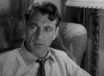 Movie still from “Casanova Brown” (1944), directed by Sam Wood – An old photo of a man wearing a neck tie; Close Up shot, Over the shoulder angle