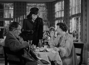 Movie still from “Casanova Brown” (1944), directed by Sam Wood – A group of people sitting around a table; Medium shot, Low angle