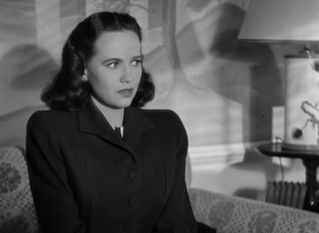 Movie still from “Casanova Brown” (1944), directed by Sam Wood – An old photo of a woman in a black suit; Close Up shot, Low angle