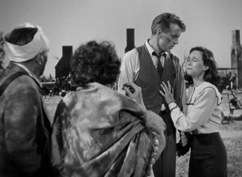 Movie still from “Casanova Brown” (1944), directed by Sam Wood – A black and white photo of a man and a woman talking; Medium shot, Over the shoulder angle