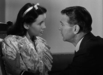 Movie still from “Casanova Brown” (1944), directed by Sam Wood – A man and a woman looking at one another; Close Up shot, High angle