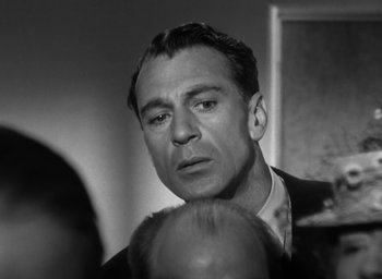 Movie still from “Casanova Brown” (1944), directed by Sam Wood – An old black and white photo of a man in a suit; Close Up shot, Over the shoulder angle