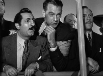 Movie still from “Casanova Brown” (1944), directed by Sam Wood – A group of men sitting next to each other on top of a bus; Medium shot, Low angle