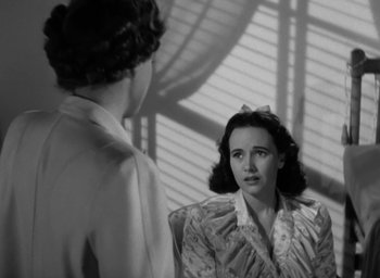 Movie still from “Casanova Brown” (1944), directed by Sam Wood – Two women are sitting in front of each other in a room; Close Up shot, Over the shoulder angle