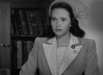 Movie still from “Casanova Brown” (1944), directed by Sam Wood – An old photo of a woman in a hat and a suit; Close Up shot, High angle