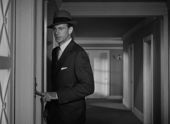 Movie still from “Casanova Brown” (1944), directed by Sam Wood – A black and white photo of a man in a suit and hat; Medium shot, Low angle