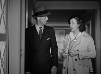 Movie still from “Casanova Brown” (1944), directed by Sam Wood – An old photo of a man and a woman; Medium shot, Low angle