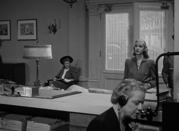 Movie still from “Casanova Brown” (1944), directed by Sam Wood – Two women are sitting at a table in a room; Wide shot, Low angle