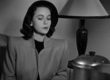 Movie still from “Casanova Brown” (1944), directed by Sam Wood – A black and white photo of a woman wearing a hat; Close Up shot, Low angle