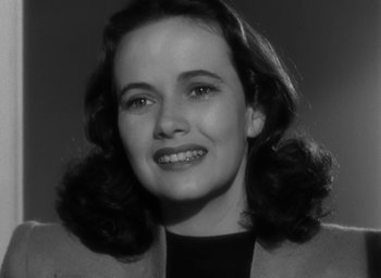 Movie still from “Casanova Brown” (1944), directed by Sam Wood – An old black and white photo of a woman smiling; Close Up shot, High angle