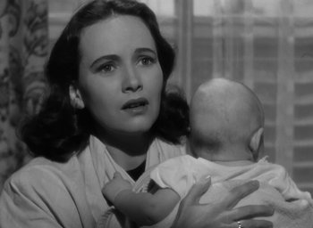 Movie still from “Casanova Brown” (1944), directed by Sam Wood – A woman holding a baby in her arms; Close Up shot, High angle