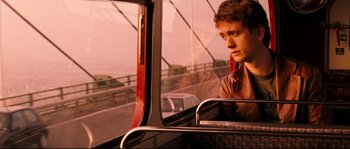 A man sitting on a bus looking out the window