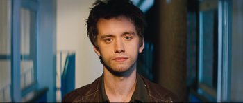 A person wearing a brown leather jacket