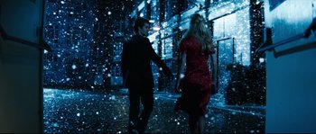 A man and a woman are walking in the snow