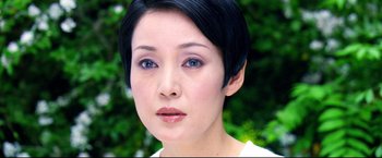 Movie still from “Casshern” (2004), directed by Kazuaki Kiriya – A person with short black hair; Close Up shot, Over the shoulder angle