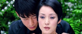 Movie still from “Casshern” (2004), directed by Kazuaki Kiriya – A man and a woman looking at the camera; Close Up shot, High angle