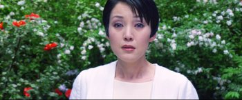 Movie still from “Casshern” (2004), directed by Kazuaki Kiriya – A person with short black hair; Close Up shot, Low angle