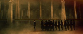 Movie still from “Casshern” (2004), directed by Kazuaki Kiriya – A group of people in black suits and helmets; Extreme Wide shot, High angle