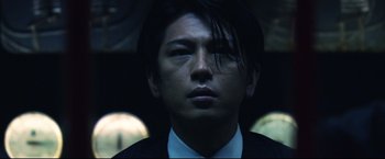 Movie still from “Casshern” (2004), directed by Kazuaki Kiriya – A person wearing a suit and tie; Close Up shot, Low angle