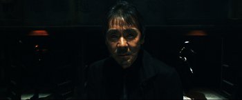 Movie still from “Casshern” (2004), directed by Kazuaki Kiriya – A man in a black jacket is looking at the camera; Close Up shot, Low angle