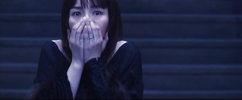 Movie still from “Casshern” (2004), directed by Kazuaki Kiriya – A woman with her hands over her mouth; Close Up shot, Over the shoulder angle