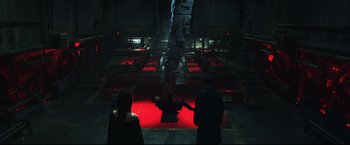 Movie still from “Casshern” (2004), directed by Kazuaki Kiriya – A group of people standing in a dark room; Wide shot, High angle