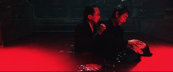 Movie still from “Casshern” (2004), directed by Kazuaki Kiriya – Two men in a pool of water at night; Medium shot, High angle