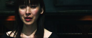 Movie still from “Casshern” (2004), directed by Kazuaki Kiriya – A person wearing a black shirt; Close Up shot, Over the shoulder angle