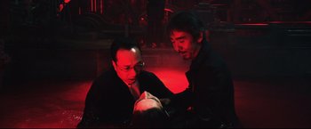 Movie still from “Casshern” (2004), directed by Kazuaki Kiriya – A couple of men sitting next to each other in a room; Medium shot, High angle