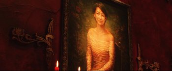 Movie still from “Casshern” (2004), directed by Kazuaki Kiriya – A painting of a woman in a yellow dress with two candles; Close Up shot, Low angle