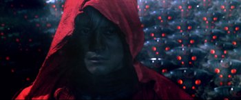 Movie still from “Casshern” (2004), directed by Kazuaki Kiriya – A man in a red hooded jacket standing in front of lights; Close Up shot, Low angle