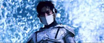 Movie still from “Casshern” (2004), directed by Kazuaki Kiriya – A man wearing a white mask and a white suit; Close Up shot, Low angle