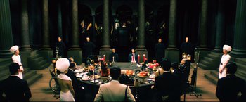 Movie still from “Casshern” (2004), directed by Kazuaki Kiriya – A group of people sitting around a round table; Wide shot, High angle