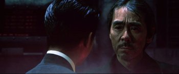 Movie still from “Casshern” (2004), directed by Kazuaki Kiriya – A person looking at a person in a mirror; Close Up shot, Over the shoulder angle