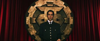 Movie still from “Casshern” (2004), directed by Kazuaki Kiriya – A man standing in front of a large circle; Medium shot, Low angle