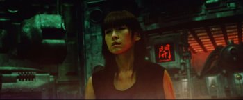 Movie still from “Casshern” (2004), directed by Kazuaki Kiriya – A woman with bangs is standing in a dark room; Close Up shot, Low angle
