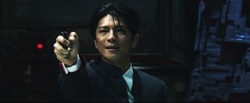 Movie still from “Casshern” (2004), directed by Kazuaki Kiriya – A man in a black suit holds his fist up; Close Up shot, Low angle