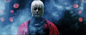Movie still from “Casshern” (2004), directed by Kazuaki Kiriya – A man with blonde hair wearing a red cape; Close Up shot, Low angle