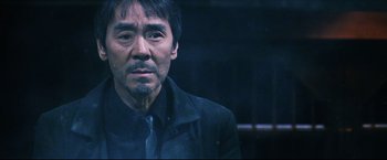 Movie still from “Casshern” (2004), directed by Kazuaki Kiriya – A person wearing a suit and tie; Close Up shot, Low angle