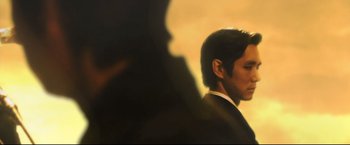 Movie still from “Casshern” (2004), directed by Kazuaki Kiriya – A man in a black suit is standing in front of a mirror; Close Up shot, Low angle