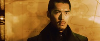 Movie still from “Casshern” (2004), directed by Kazuaki Kiriya – A person wearing a black shirt; Close Up shot, Low angle