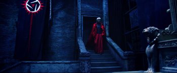 Movie still from “Casshern” (2004), directed by Kazuaki Kiriya – A man in a red robe walking down a set of stairs; Wide shot, Low angle