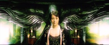 Movie still from “Casshern” (2004), directed by Kazuaki Kiriya – A woman in a black and white dress with a black angel wings; Medium shot, Low angle