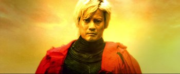 Movie still from “Casshern” (2004), directed by Kazuaki Kiriya – A woman with blonde hair wearing a red jacket; Close Up shot, Low angle