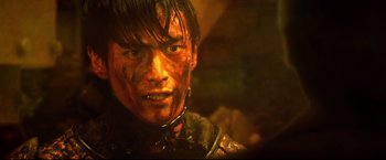 Movie still from “Casshern” (2004), directed by Kazuaki Kiriya – A person wearing a costume; Close Up shot, Over the shoulder angle