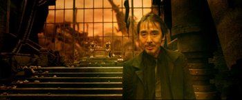Movie still from “Casshern” (2004), directed by Kazuaki Kiriya – A man standing in front of a staircase; Medium shot, High angle