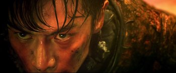 Movie still from “Casshern” (2004), directed by Kazuaki Kiriya – A man's face with a lot of dirt on his face; Extreme Close Up shot, High angle