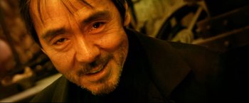 Movie still from “Casshern” (2004), directed by Kazuaki Kiriya – A person with a beard; Close Up shot, Over the shoulder angle