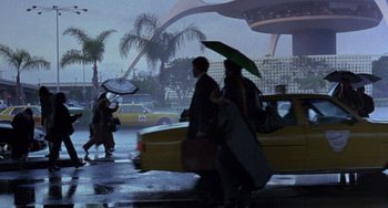 Movie still from “The Craft” (1996), directed by Andrew Fleming – A couple of people that are walking in the rain; Extreme Wide shot, Low angle