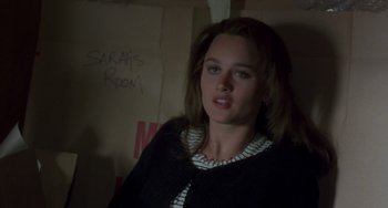 Movie still from “The Craft” (1996), directed by Andrew Fleming – A woman in a black and white striped jacket; Close Up shot, Over the shoulder angle